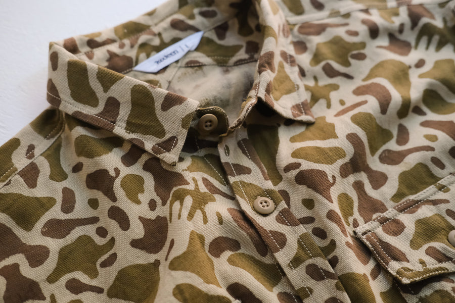 A close up photo of a camouflage printed shirt.