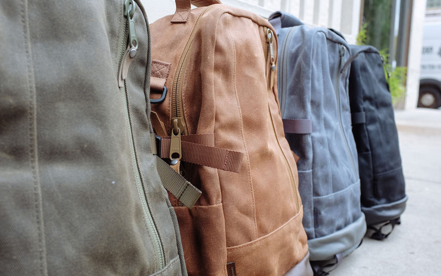 An angled low view of the four backpacks in the same order.