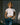 A lady in a white tee and light blue jeans in the sunset.