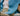 A closeup photo showing the texture of the blue sweater and the tan herringbone pants.