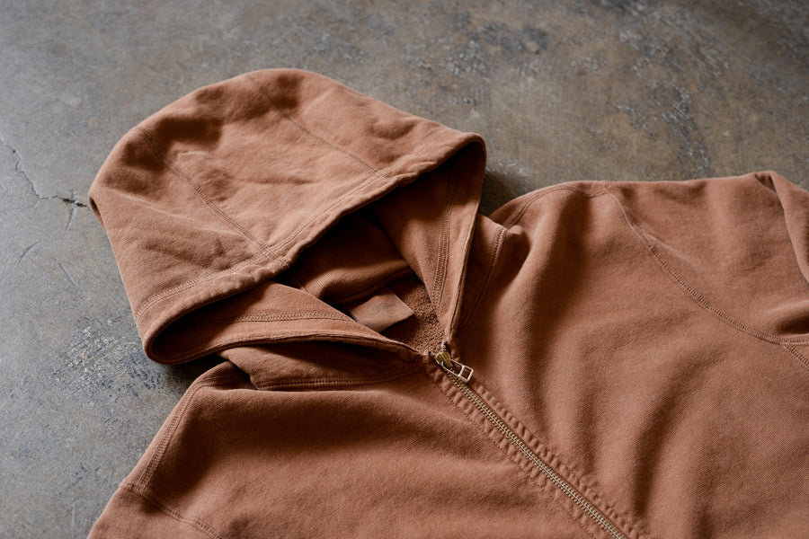 Our Clove garment dyed hoody lying on the ground.