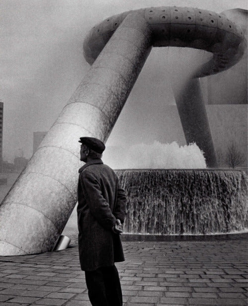 Noguchi standing by his sculpture in Hart Plaza, Detroit.