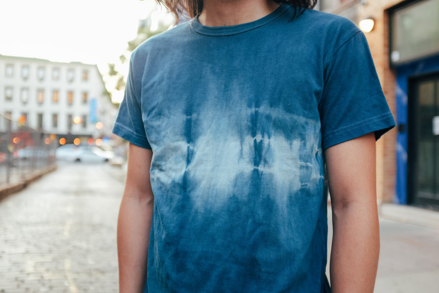 An up close look at the irregular dye pattern across the chest of a shibori-dyed tshirt.