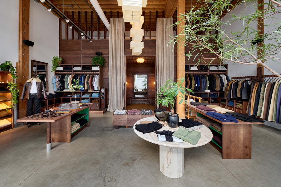 A photo of a retail store with concrete floors, and dark wood walls reaching up to the ceiling.