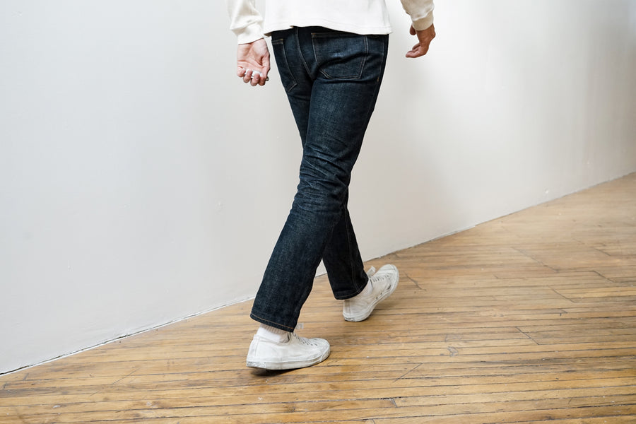 The model wears a pair of the new 3sixteen NT jeans in indigo selvedge as he walks away from the camera.