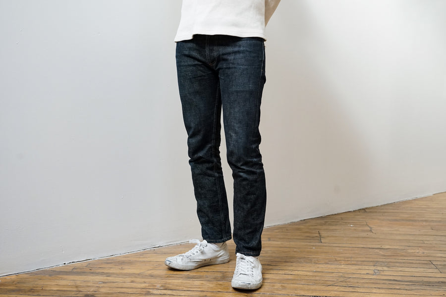 The model stands still giving a full view of the NT jeans from the front. 