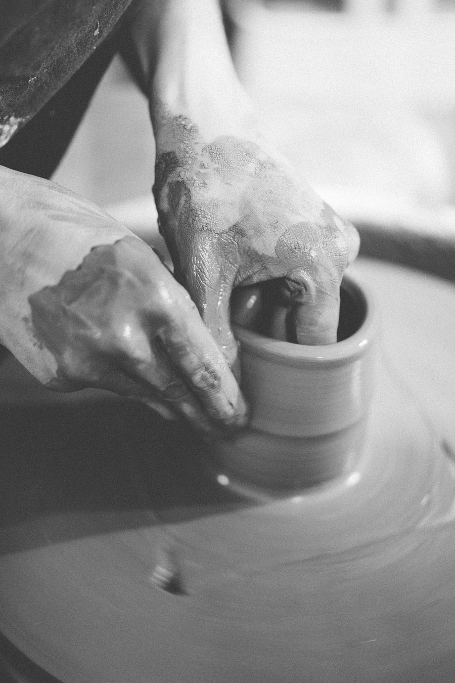 Close up of man molding clay.