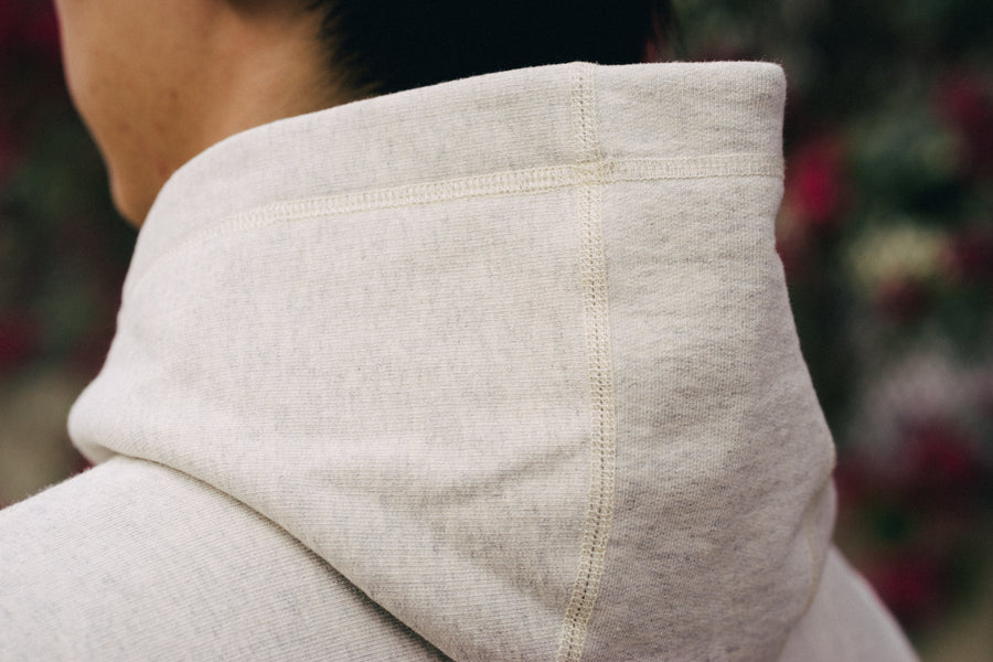 Close up image showing the stitch detail on the hood of the oatmeal pullover