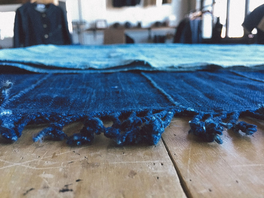 A closeup detail shot of the tassels on the end of the indigo blanket.