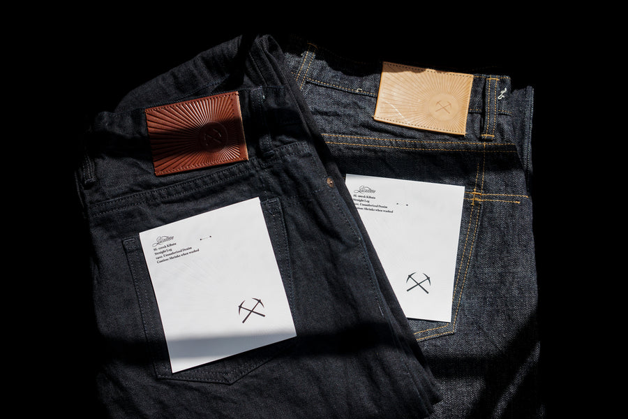 A closeup of the 3sixteen kibata jean patch, which features a pickaxe logo surrounded by radiant streams of sunlight.