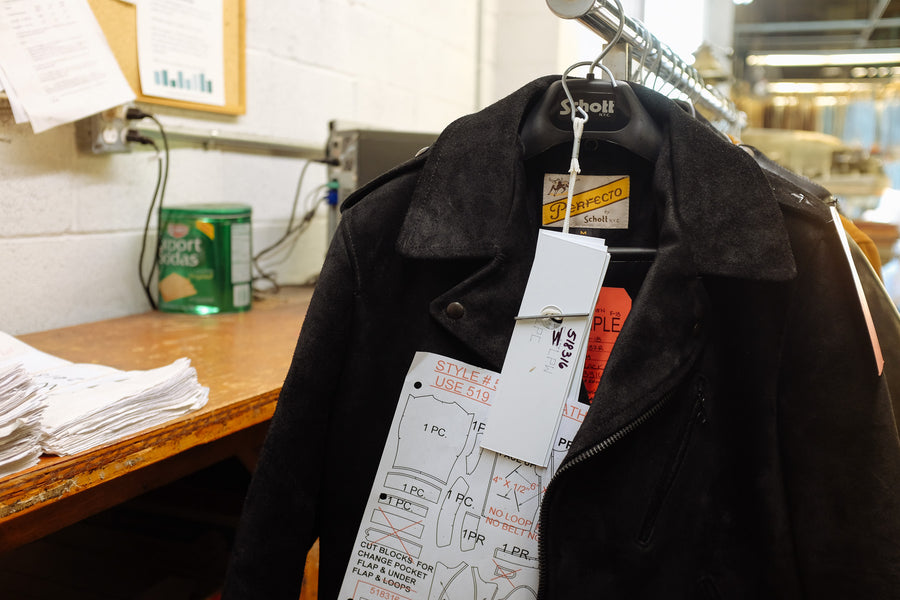 A sample jacket at the Schott factory hangs on a rack with detailed patterns attached to it.