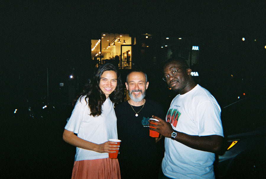 Three friends outside the shop.