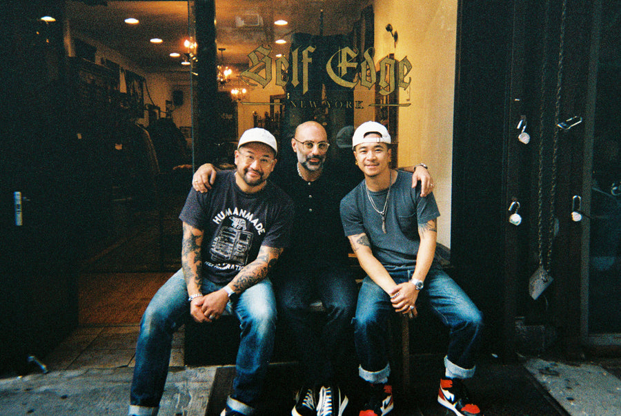 Andrew, Kiya and Johan sitting on a bench outside Self Edge New York.
