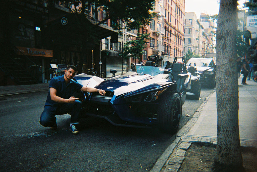 Austin crouching next to a Slingshot.