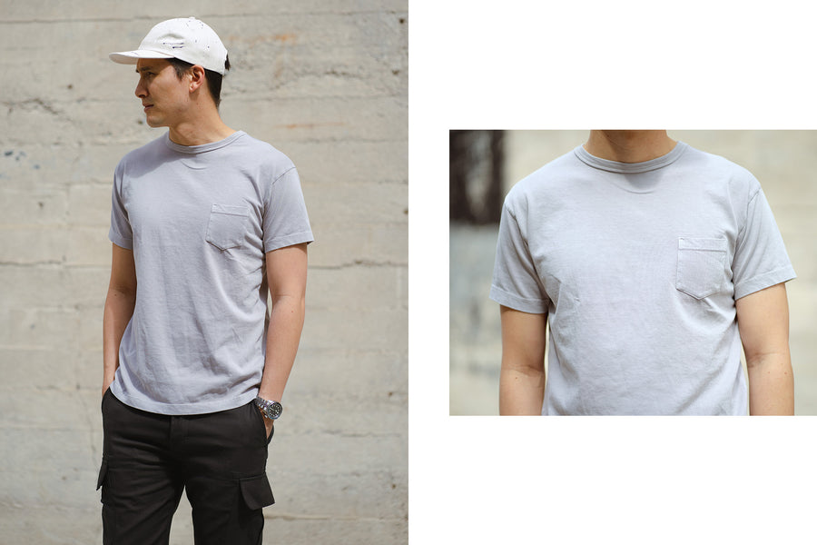 A diptych of a man wearing our ash garment dyed pocket tee, standing in front of a white wall.