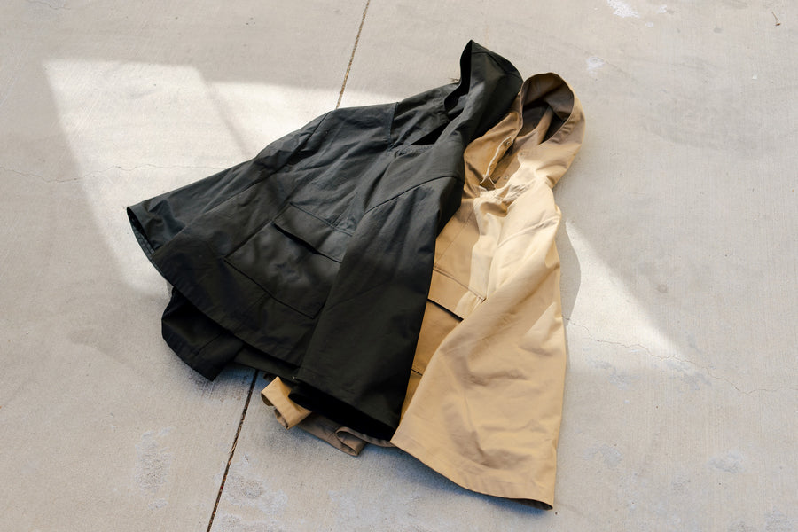 Two ponchos lay on the ground