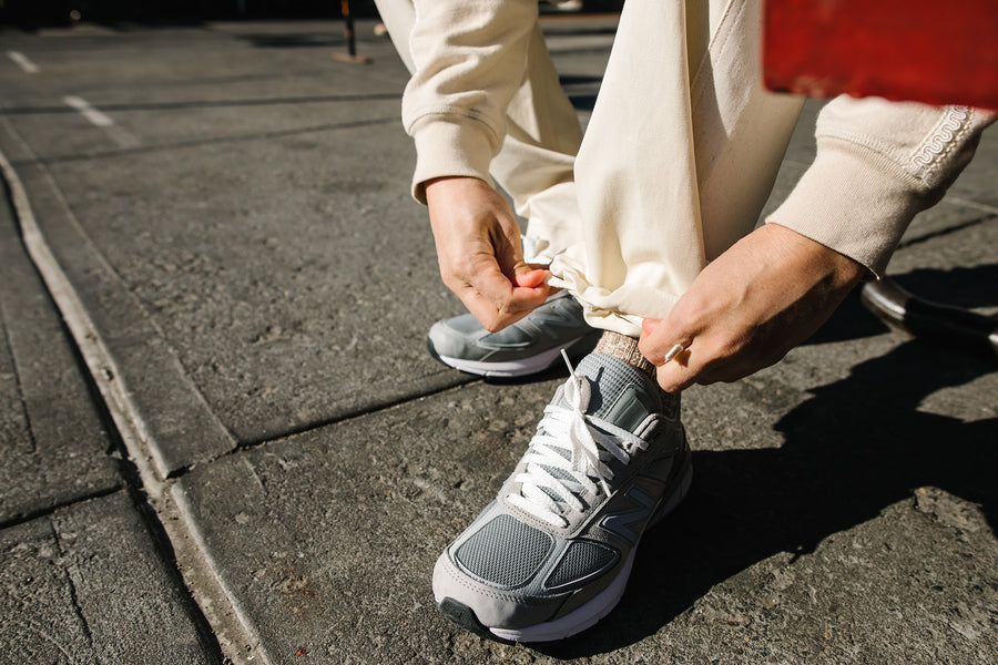 A man cinches up his fatigue pants.