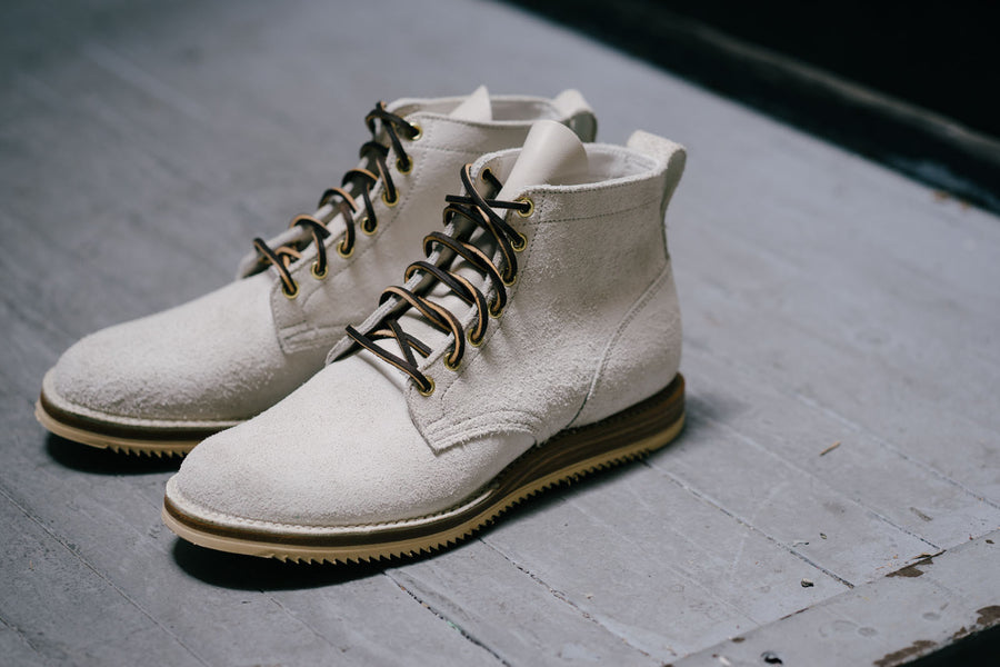 The unstructured toebox shows a round toe shape paired with a Vibram mini ripple sole.