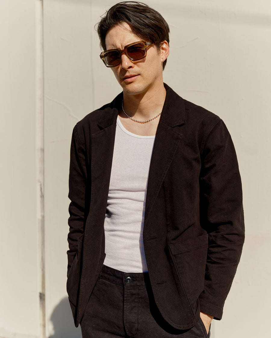 A portrait of a man in a black blazer.