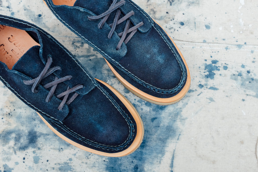 A top-down view of the indigo moccasins.